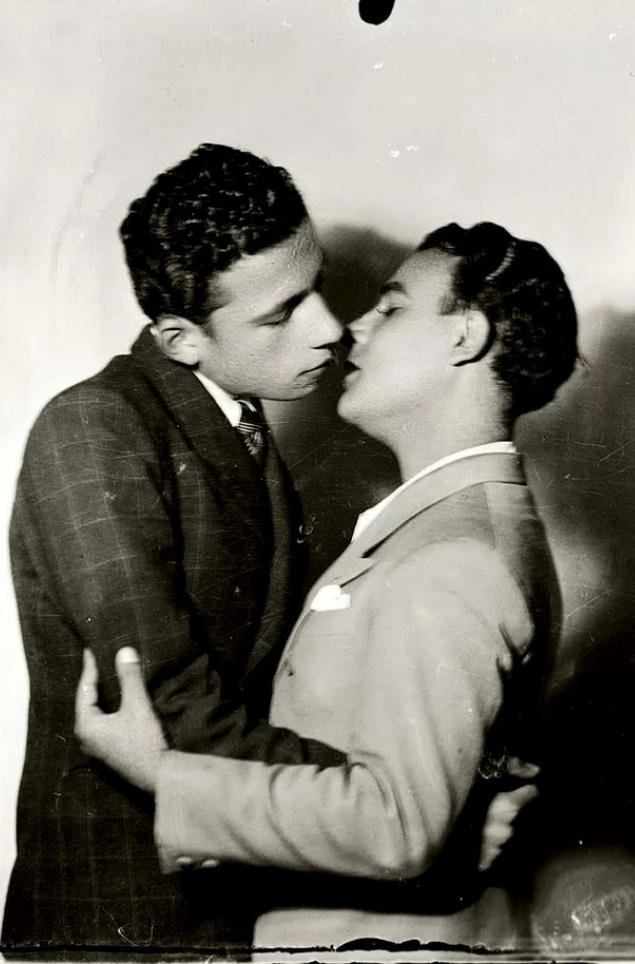 Portrait of two men kissing